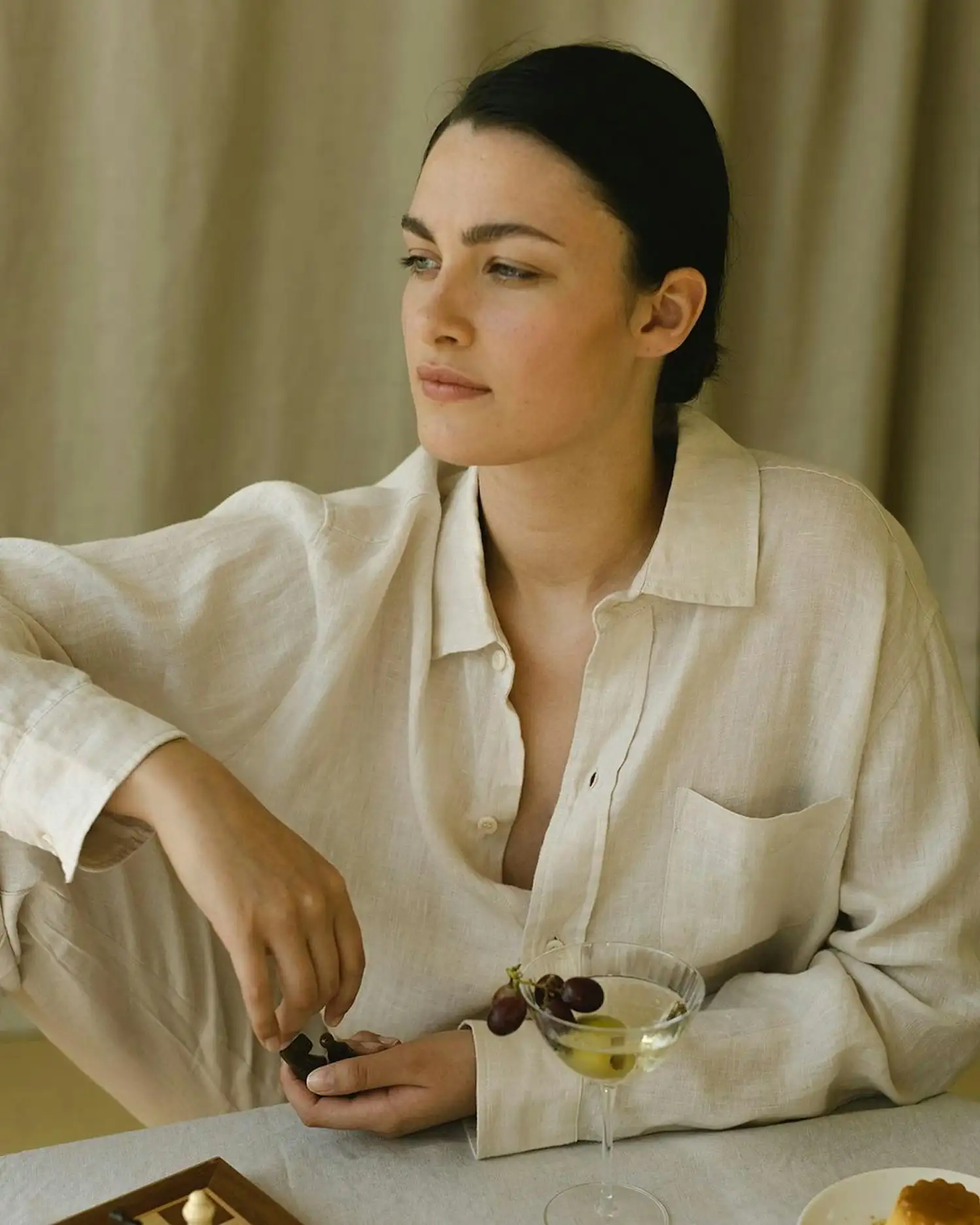 a woman sitting at a table with a tray of food