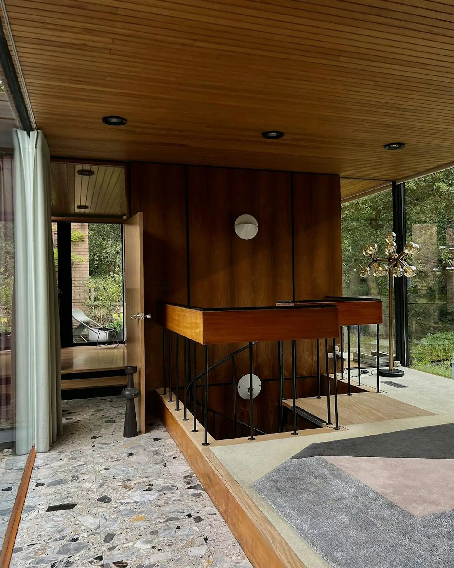 a room with a wooden floor and a glass wall